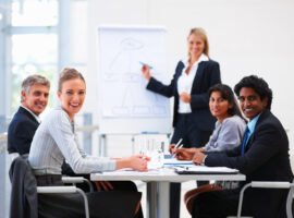 Portrait of confident happy business people sitting in a conference for training